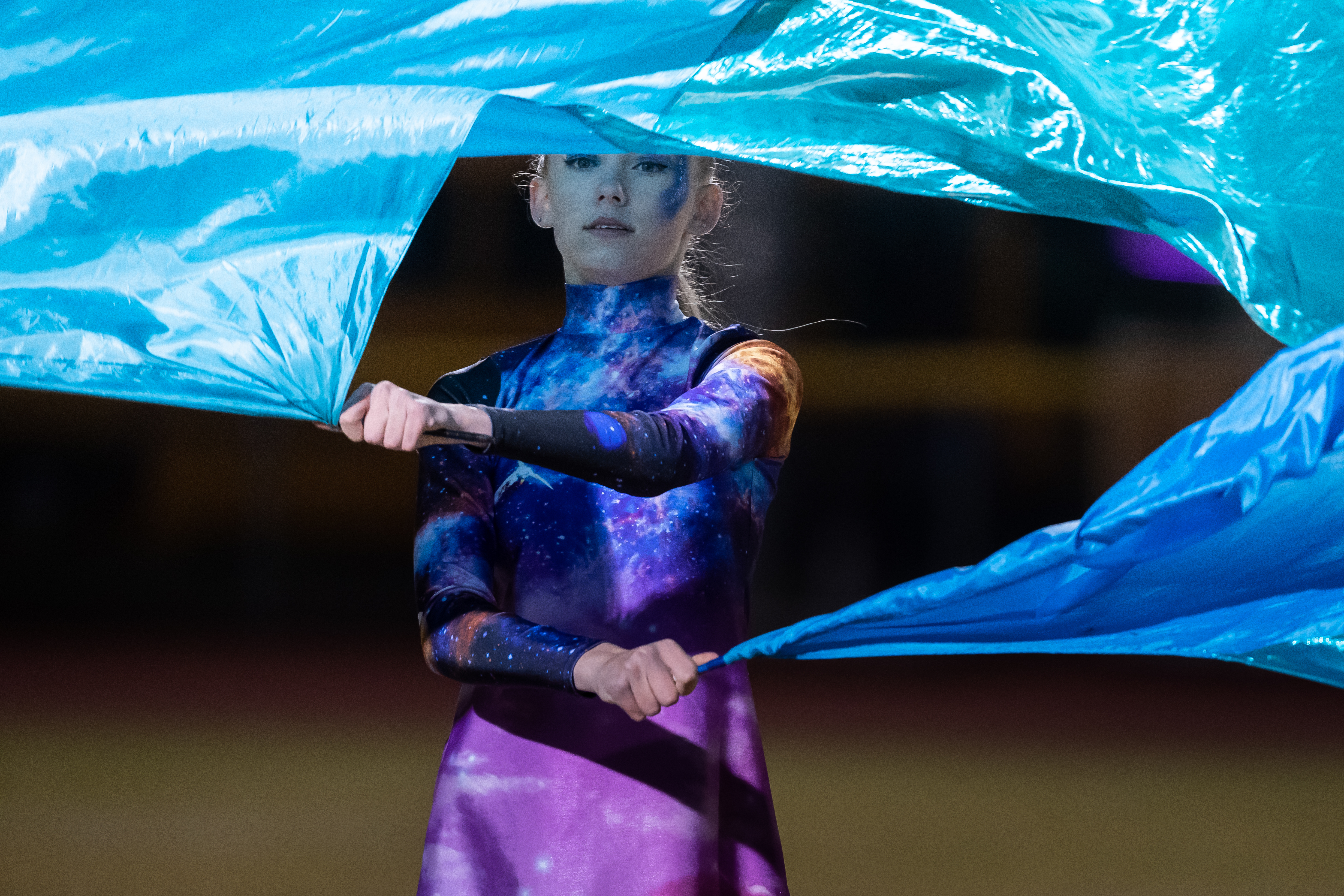 Guard student twirling flag.