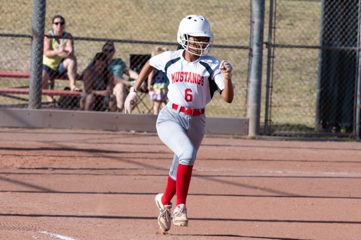 student playing in a softball game