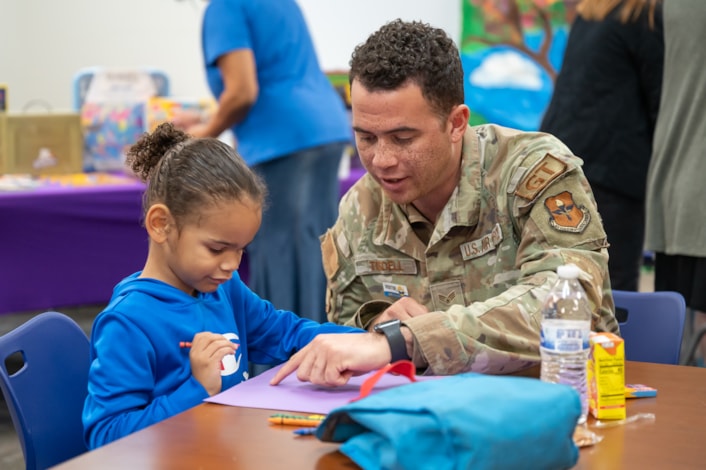 Military Airman works with student