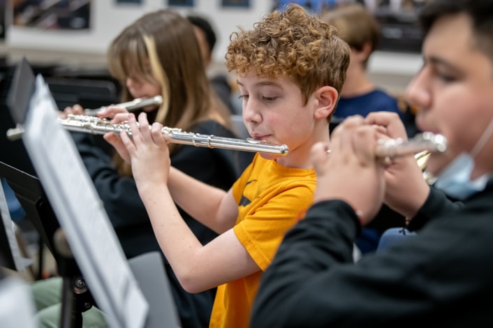Student playing the flute in band class