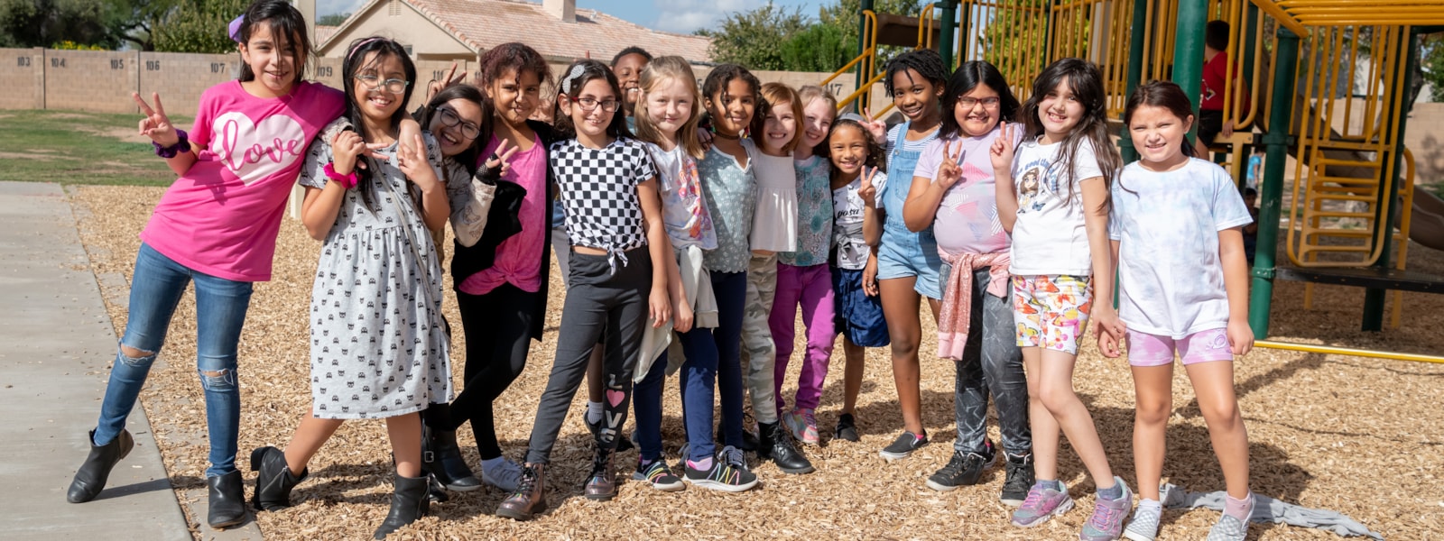 group of students smiling on playground