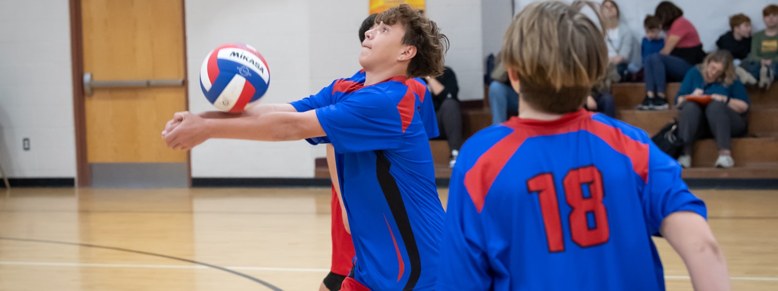 Ashton Ranch boys volleyball team playing in a game