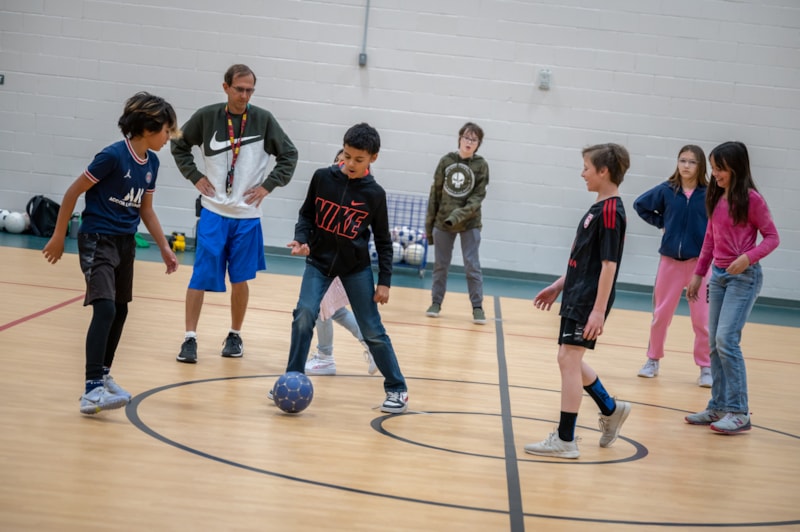 students playing soccer in PE class