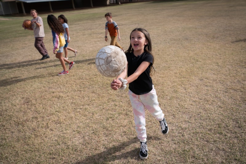 student holding soccer ball