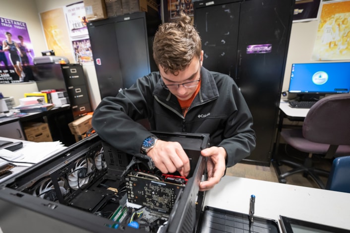 Student fixing computer