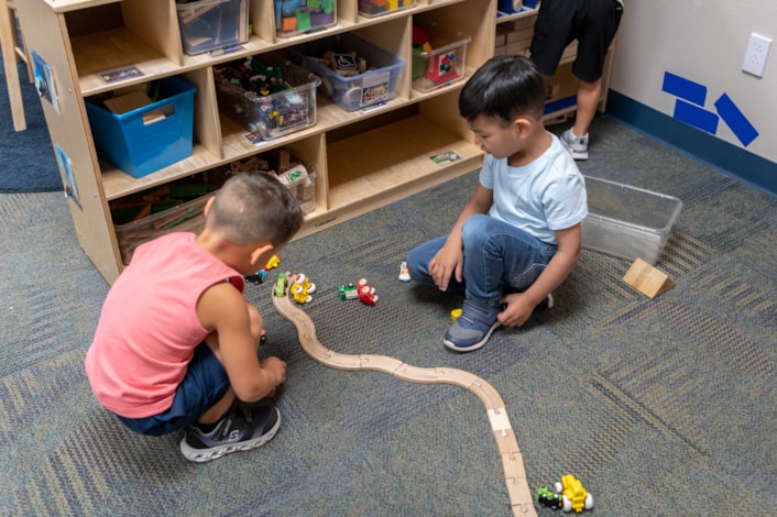preschool students building train track