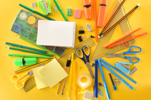 school supplies laid out on a yellow background