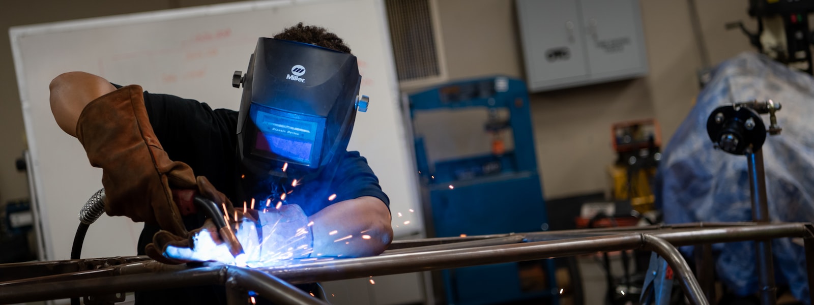 Student welding in automotive CTE class
