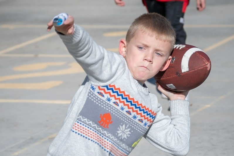 Child throwing football