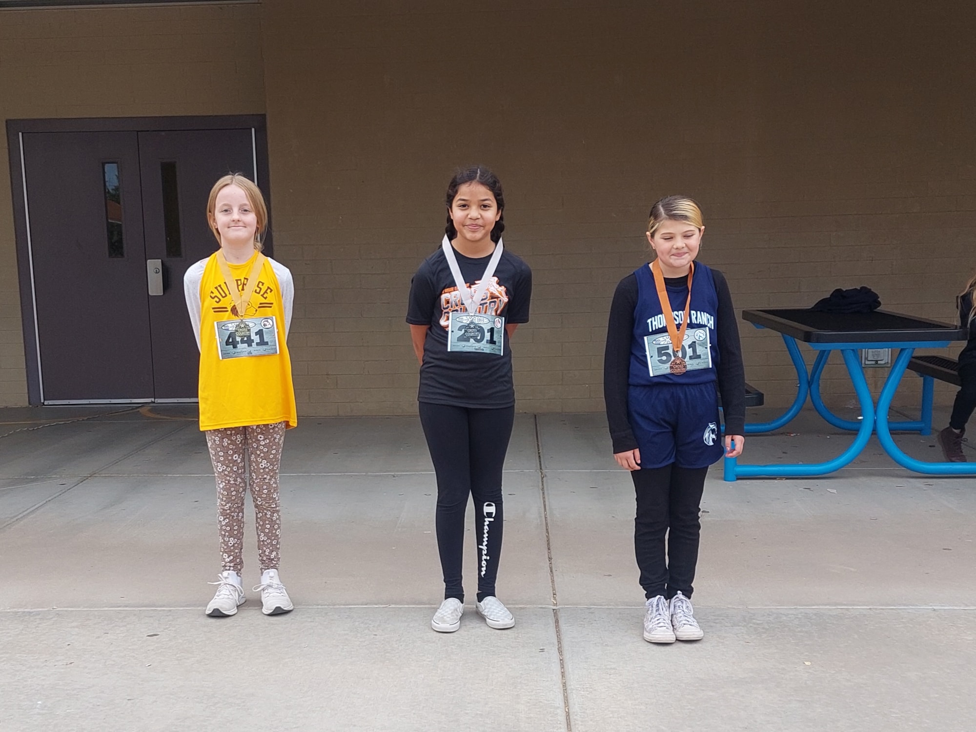 Students wearing cross country medals.