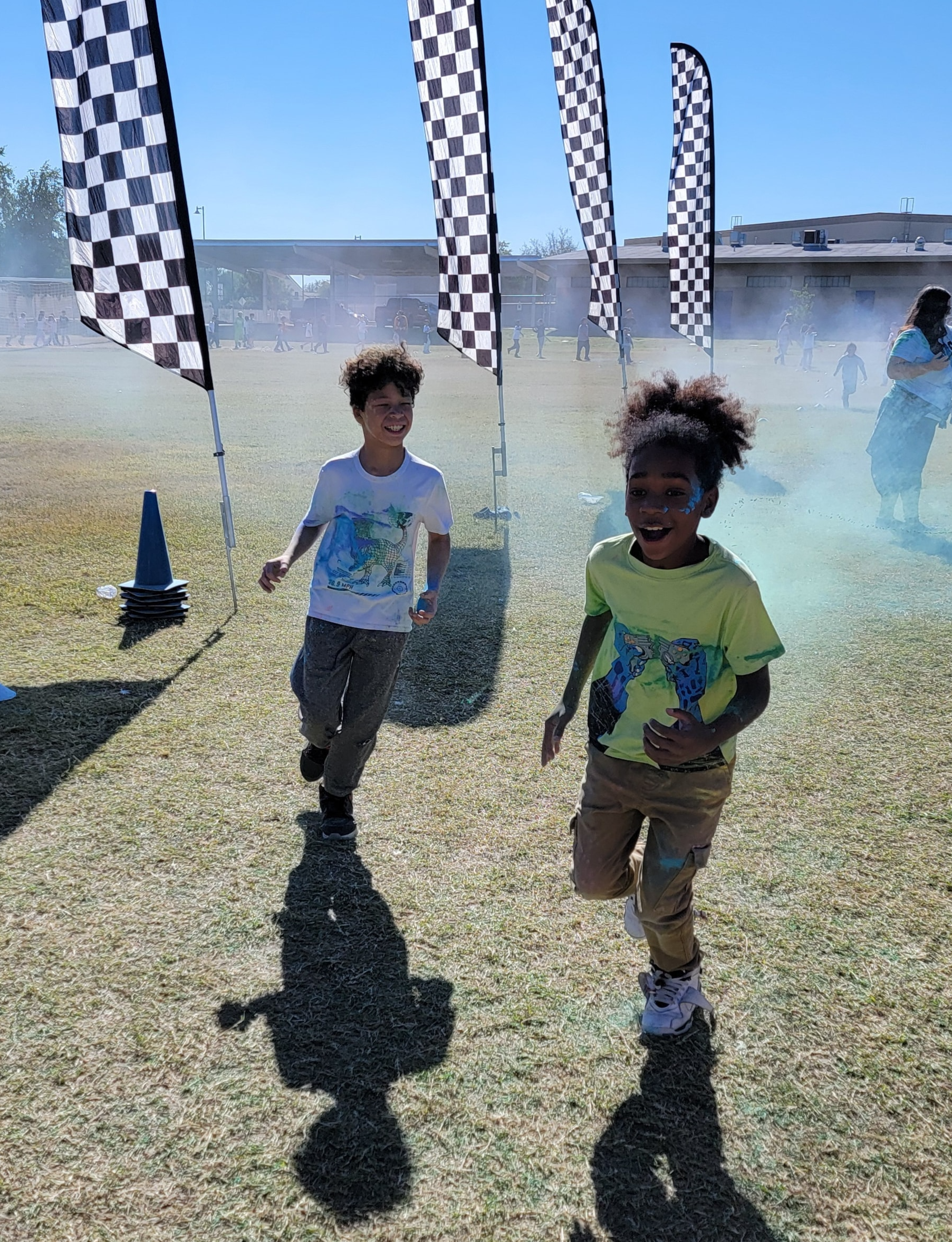 2 students getting sprayed with color.