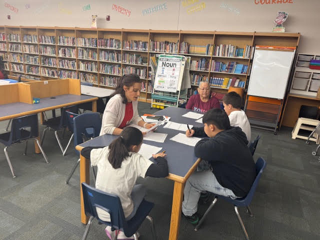 Teacher working with students.