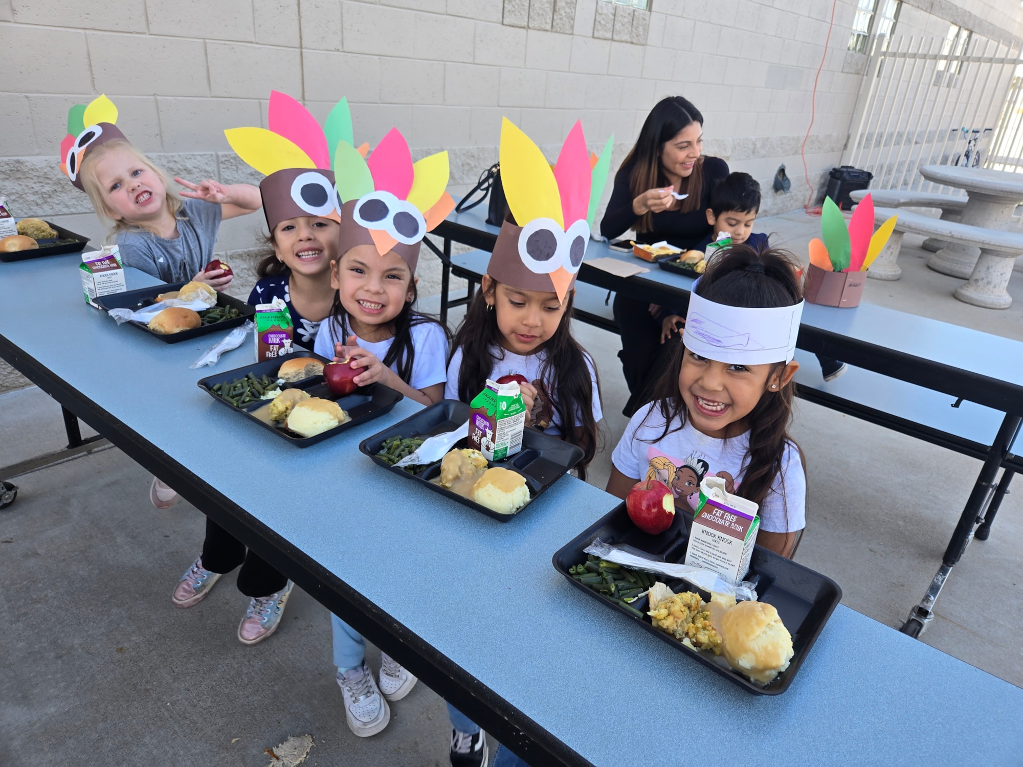 Preschool students eating Thanksgiving Lunch.