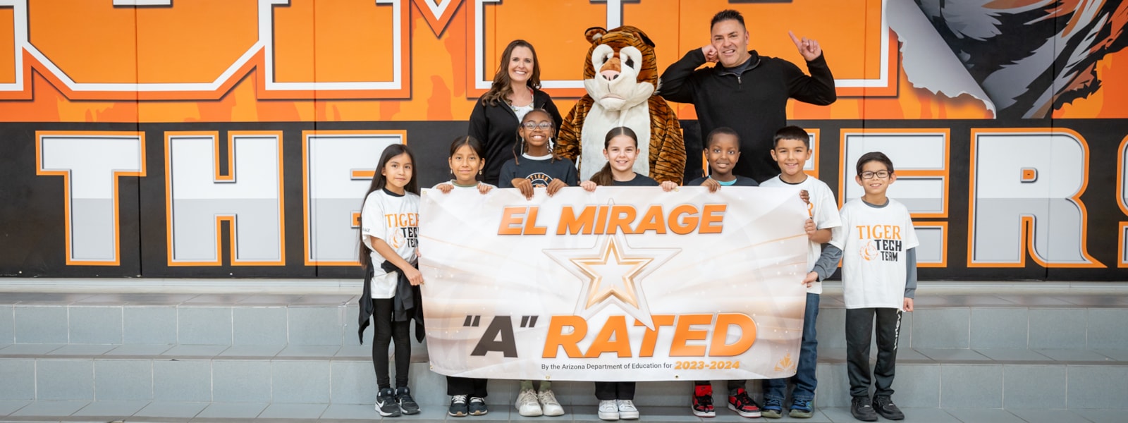 Mr. Haney and Ms. Ireland with students and banner
