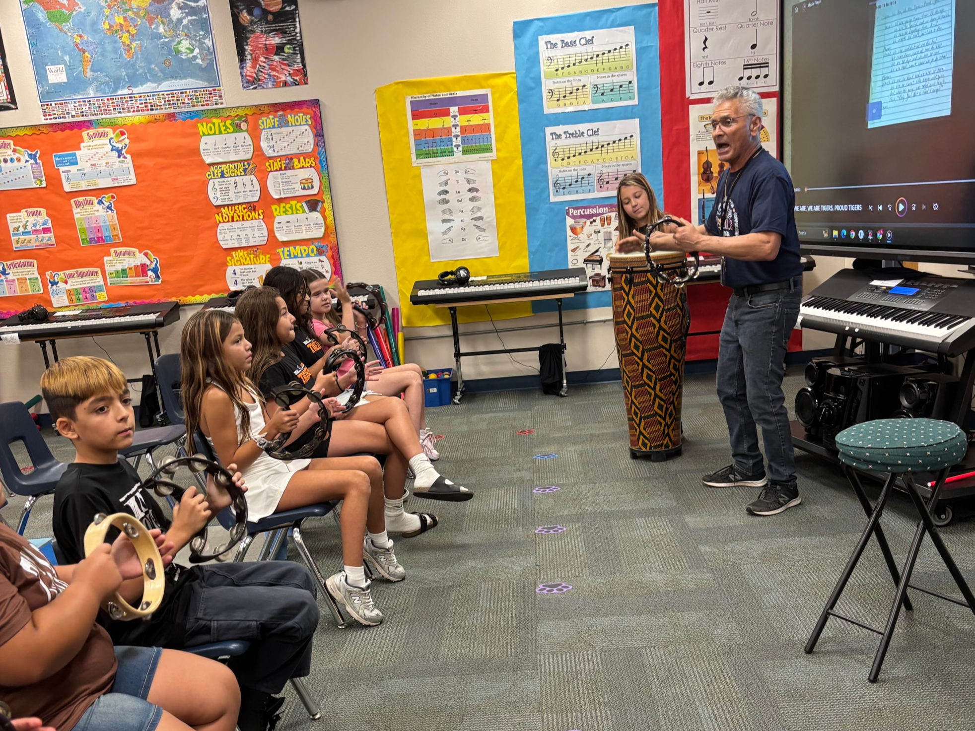 Students singing and playing instruments with Mr. Mendivil.