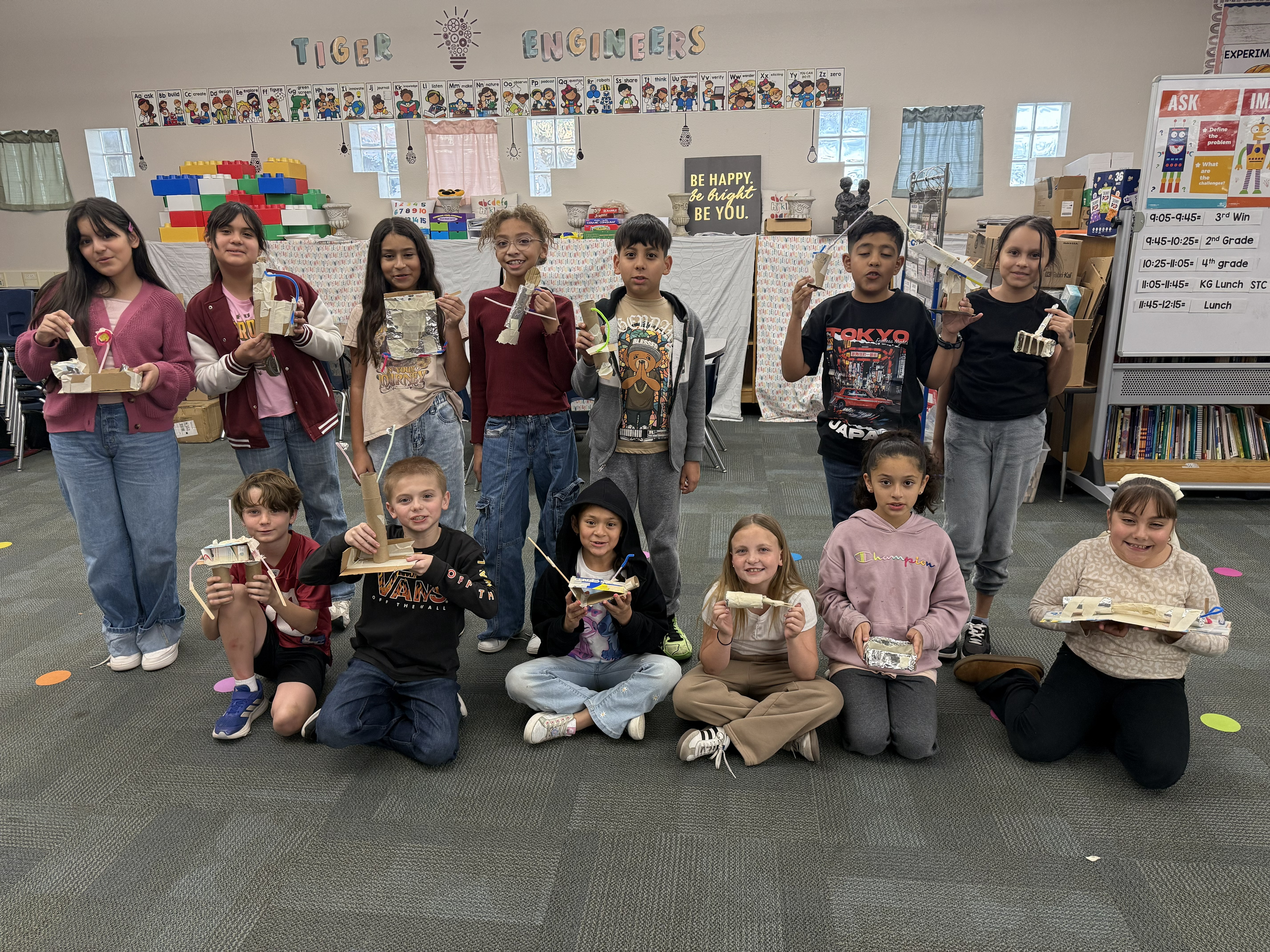 Students holding up their STEM projects.
