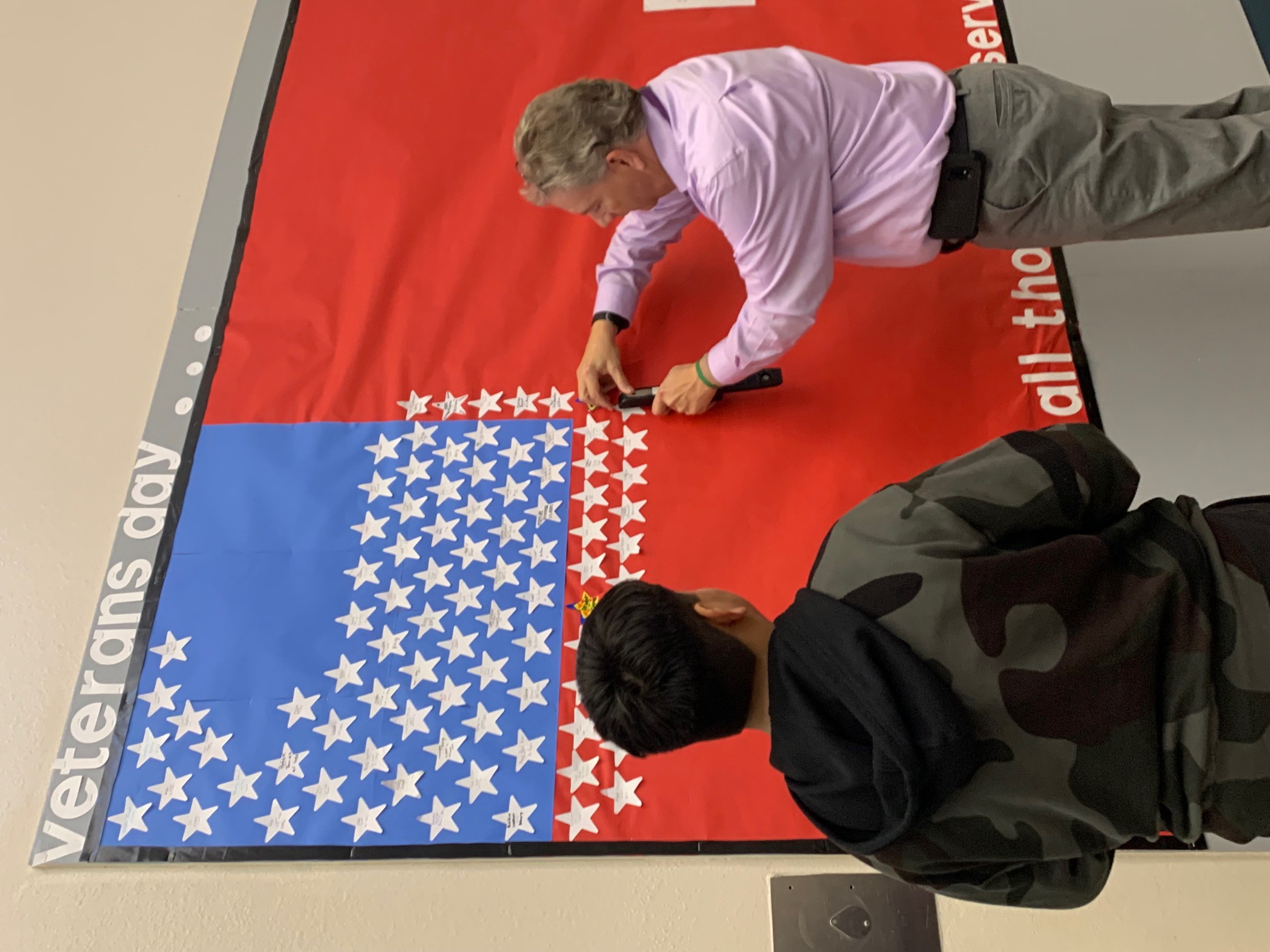 class hanging stars on a flag