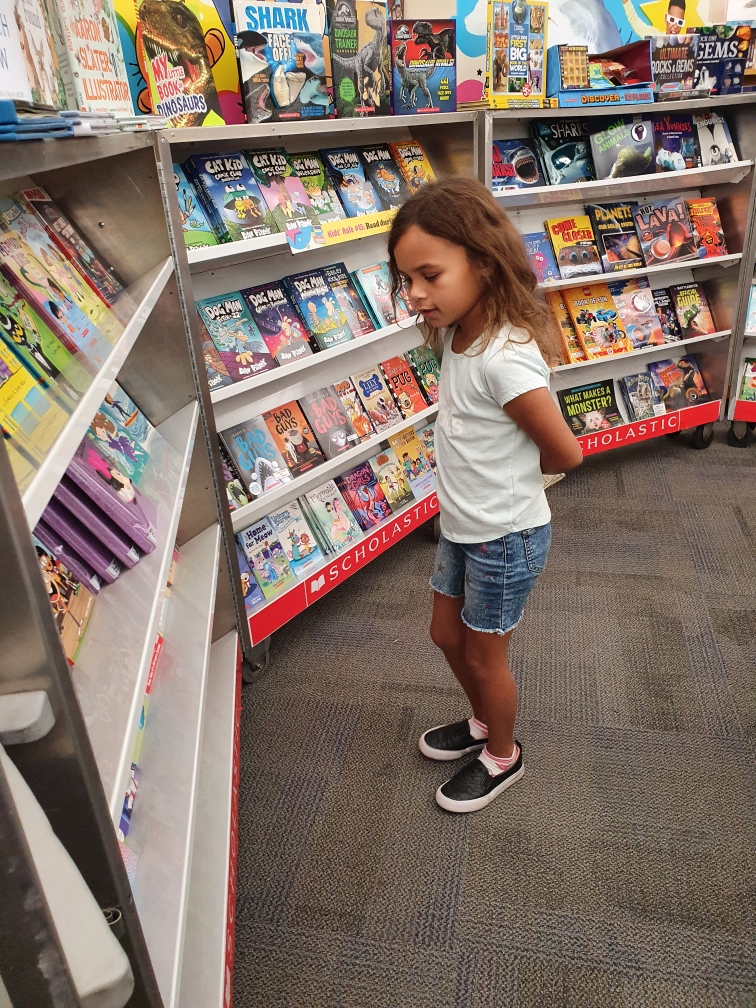 student looking at books