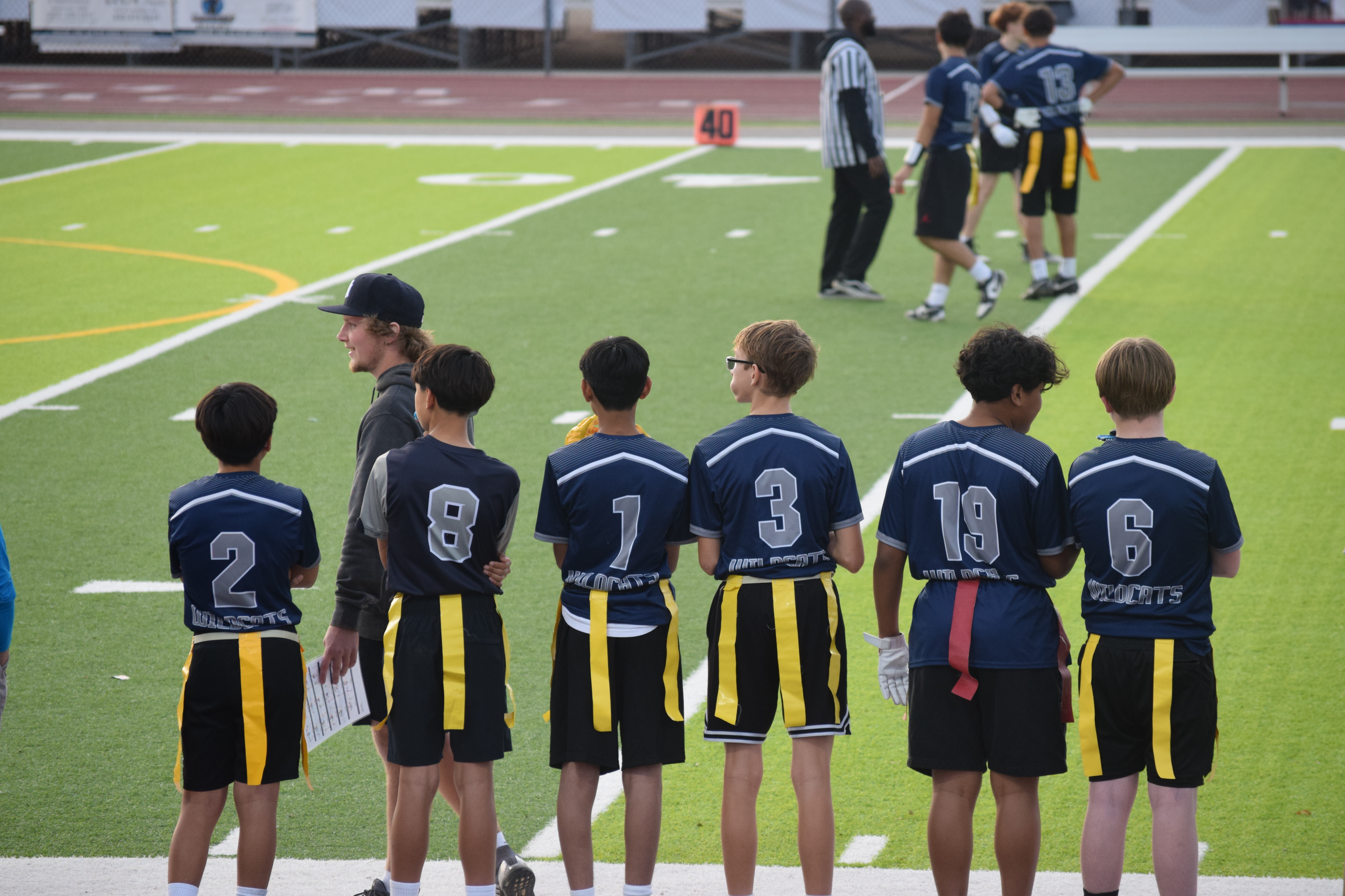 Student Athletes on Sidelines at Flag Football Game