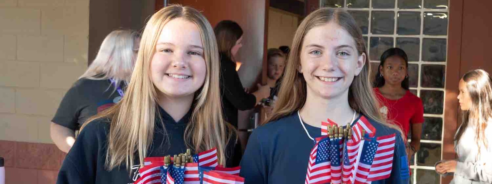 two students holding flags