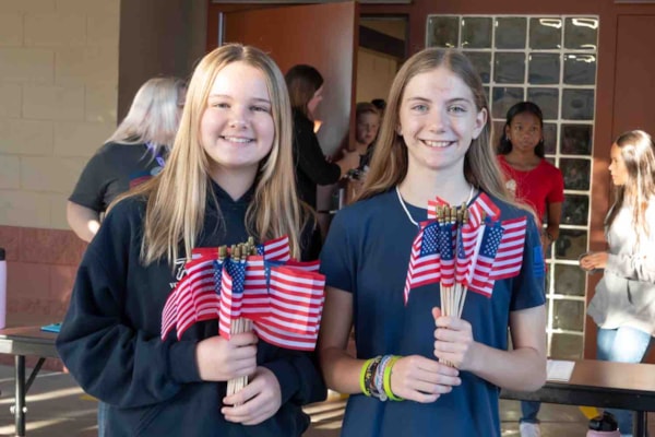 two students holding flags
