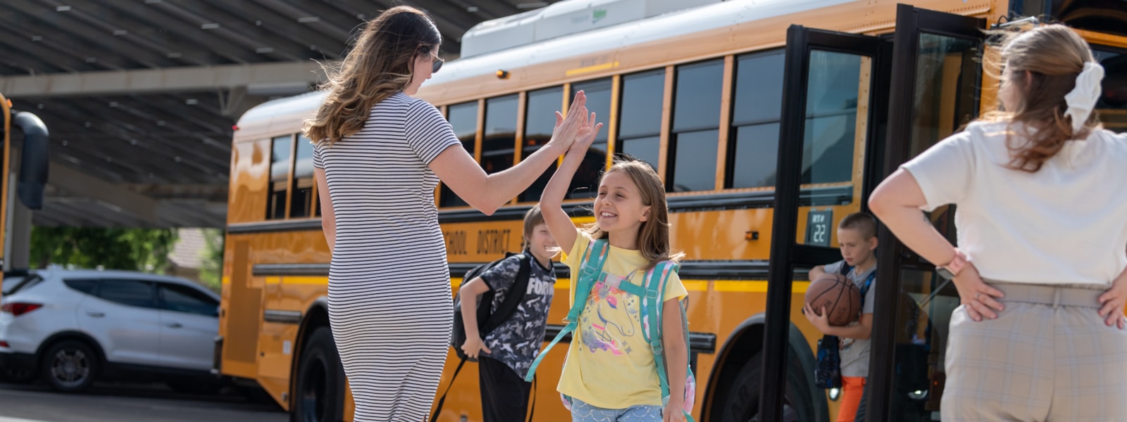 Student high-fives teacher on first day of school