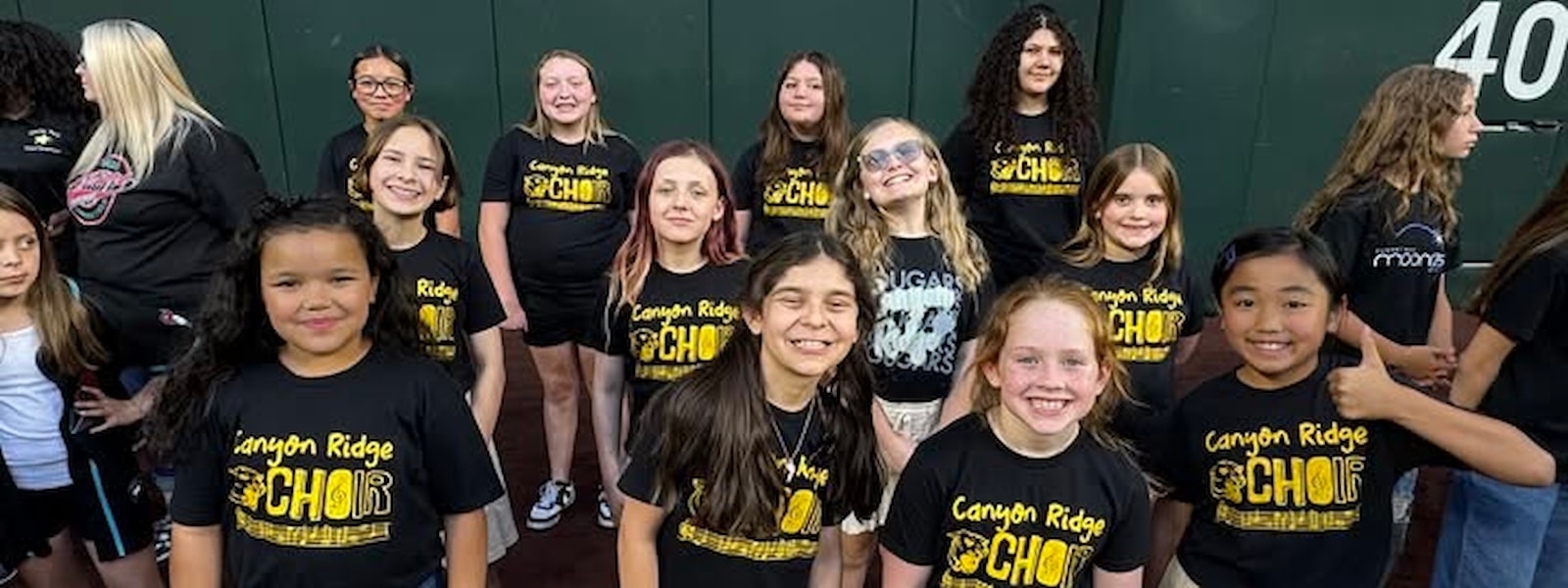 choir club student pose at the ballfield