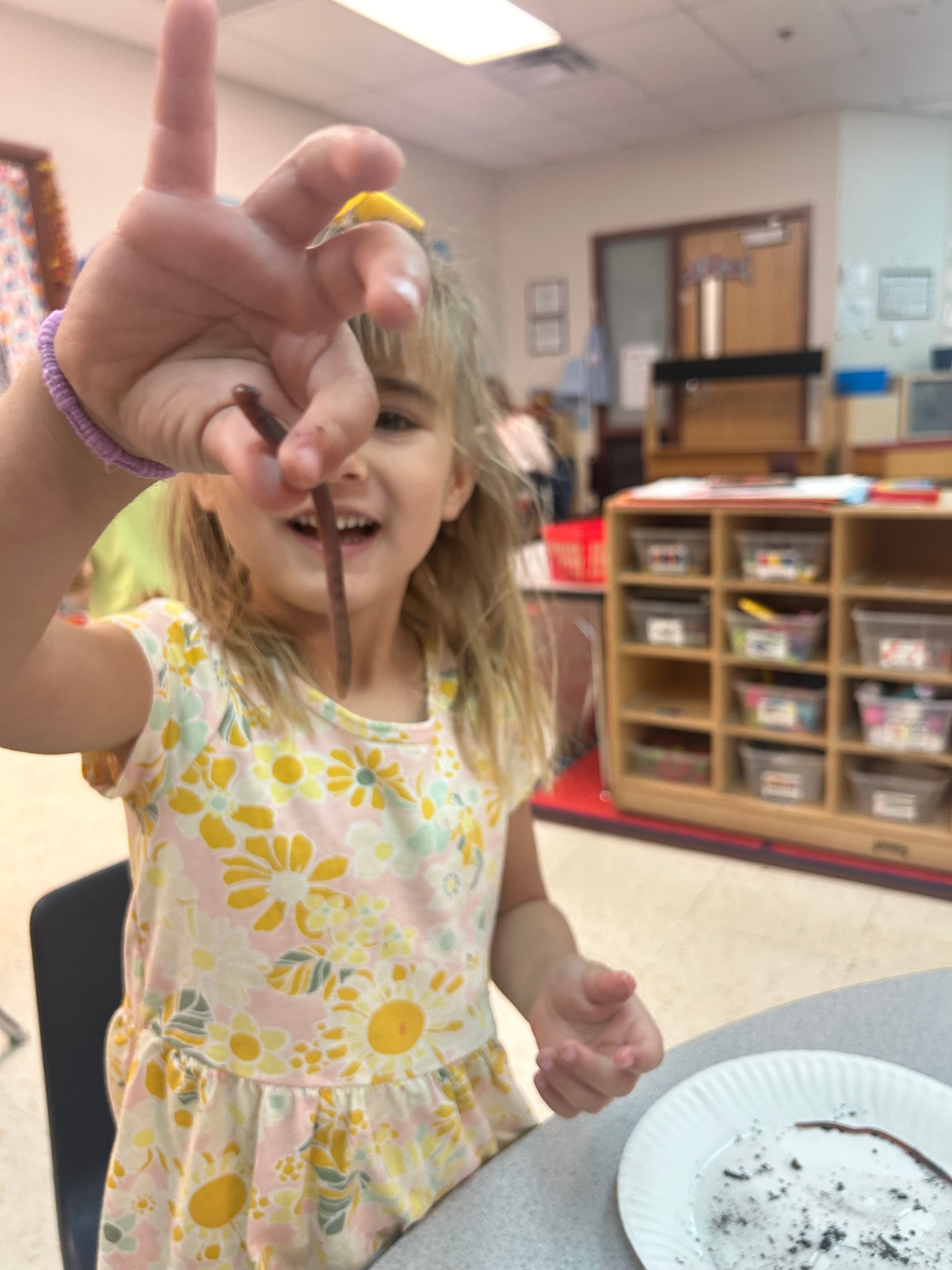 Student holding an earth worm