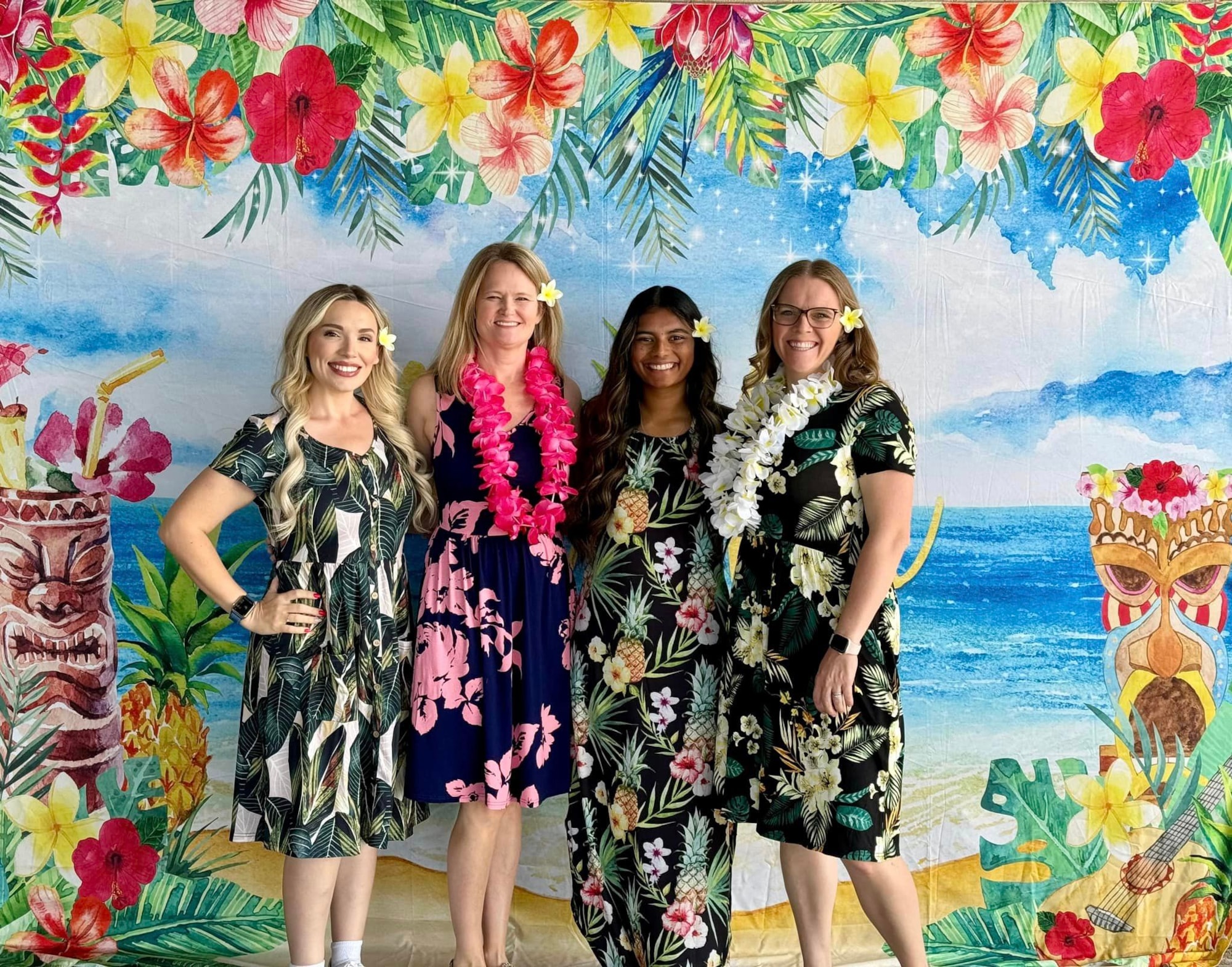 Kindergarten teachers dressed in Hawaiian clothes with a luau background