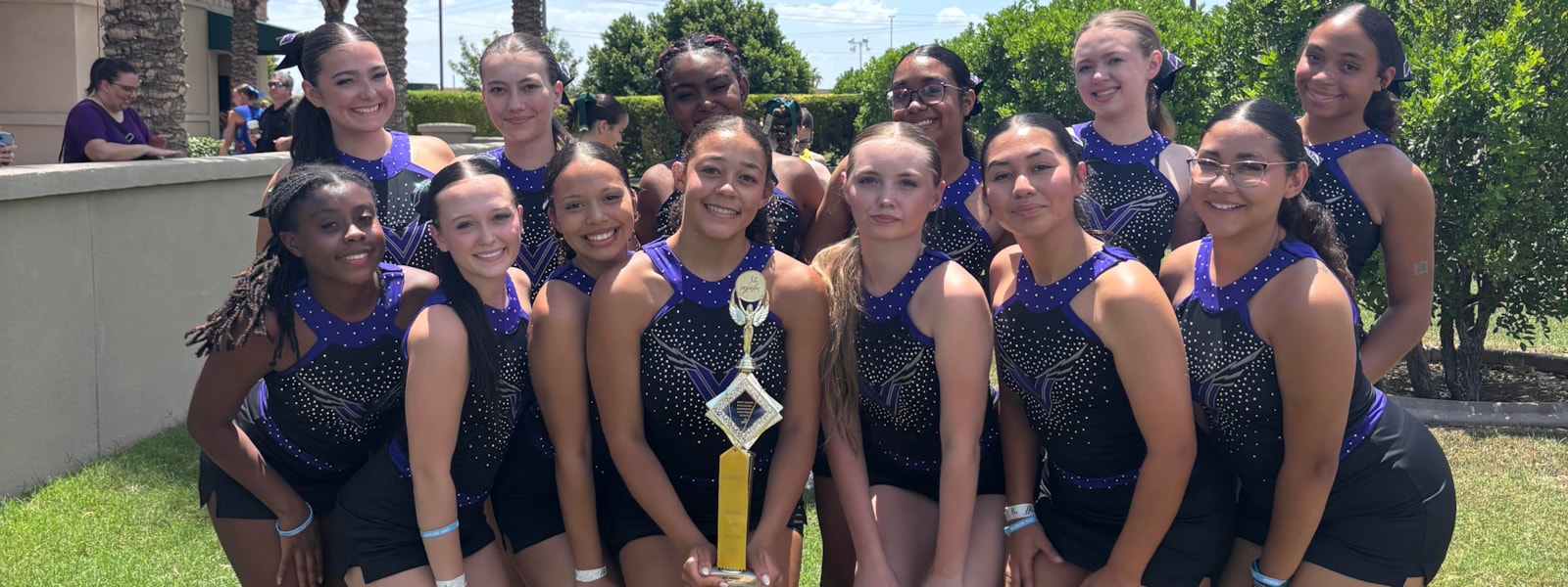 POMS team with trophy