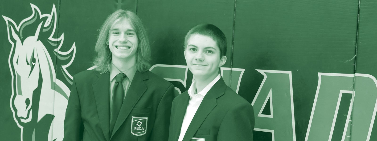 Noah Axelson (left) and Stephen MacKeller (right) pose for a photo in their gymnasium. They worked to create the Financial Fitness in Action Program at the school.